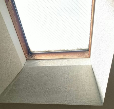 階段上の天窓　雨漏りで木枠がシミ　クロス浮き